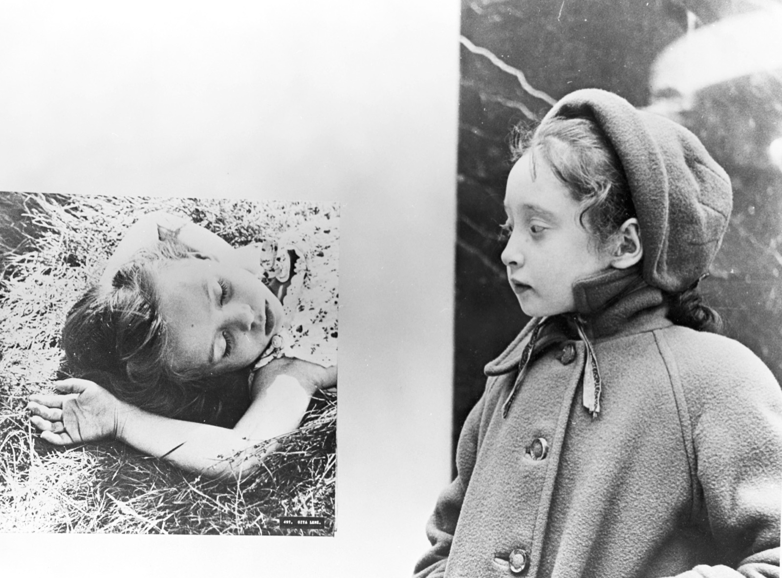 Schoolchildren viewing a Family of Man installation; large prints surround them