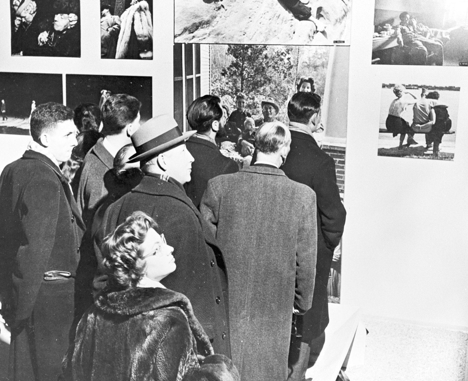 Visitors at a Family of Man installation, captioned 'Opening Day'