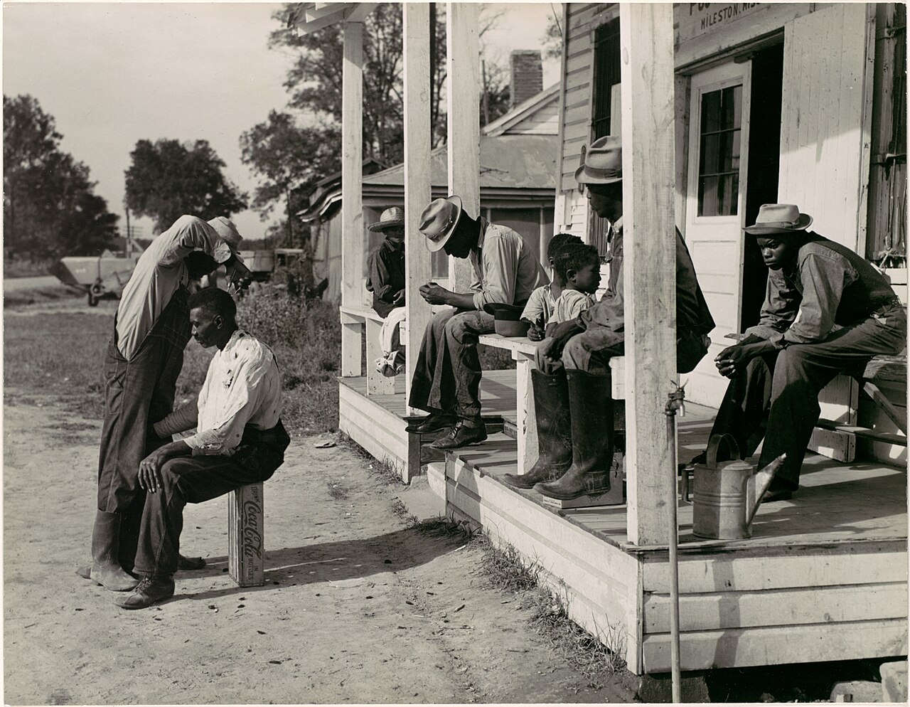 Marion Post Wolcott, open-air barber at work, Mileston, Mississippi, 1939
